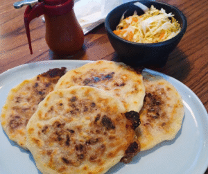 Pupusas with tomato sauce and curtido